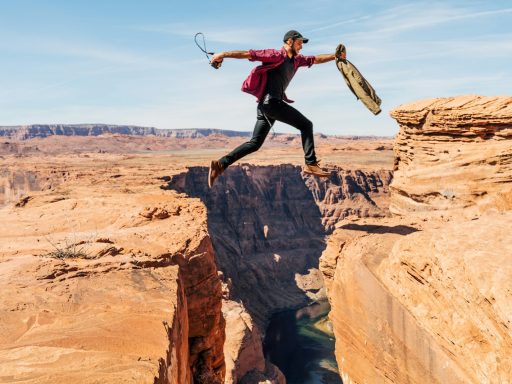 man jumping on rock formation