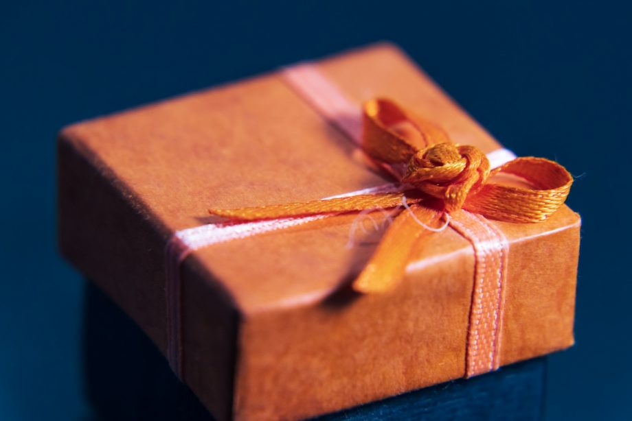 an orange wrapped gift box with a bow