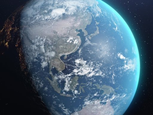 Een verlichte aardbol die ronddraait in de ruimte, zichtbaar vanuit de atmosfeer